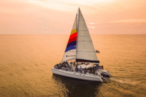 Island Time catamaran under sail in golden evening light